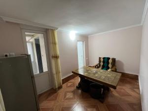 a room with a table and a chair in it at luiza in Batumi