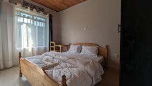 a bedroom with a large bed with a window at La Roca in Kiryi
