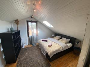 a bedroom with a large bed in a attic at Exceptional house with a pool in Jarrie