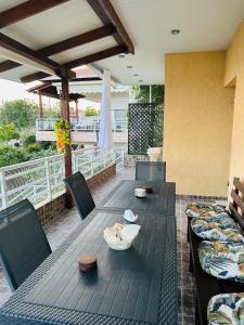 a cat laying on a table on a patio at Elaia Horizon Makri in Alexandroupoli
