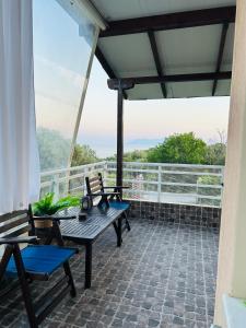 a patio with a table and chairs on a balcony at Elaia Horizon Makri in Alexandroupoli