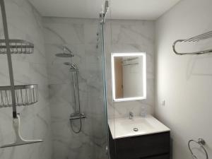 a bathroom with a shower and a sink and a mirror at Casa Santos Faro Beach in FAO