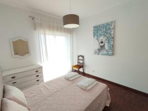 a bedroom with a bed and a window at Casa Santos Faro Beach in FAO