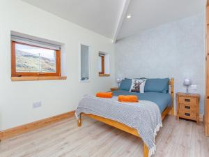 a bedroom with a blue bed and a window at Beinn Uidhe Studio Apartment - Uk49100 in Inchnadamph