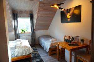 a bedroom with a bed and a desk and a table at Koziołkowo in Bartoszylas +178 photos