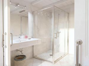 a bathroom with a glass shower and a sink at Sevilla Home Center in Seville +65 photos