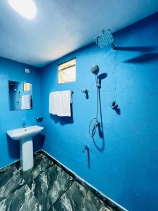 a blue bathroom with a sink and a shower at Hobbit in Midigama East +17 photos