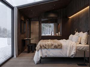 a bedroom with a bed and a large window at Halo Igloos Resort in Rovaniemi