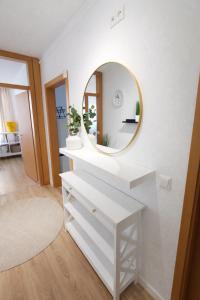 a bathroom with a white vanity and a mirror at Stilvolle Residenz am LU Mitte in Ludwigshafen am Rhein