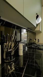 a kitchen with a counter top with utensils at Esal Manas in Jalal-Abad