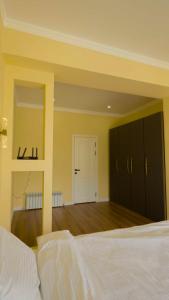 a large bedroom with a bed and a mirror at Esal Manas in Jalal-Abad