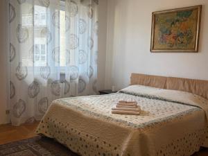 a bedroom with a bed with two towels on it at Apartment NicoCeli in Châtillon