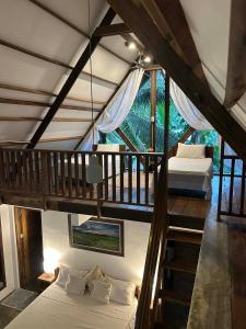 a bedroom with two beds in a room with a balcony at Libertad Surf Villa in General Luna