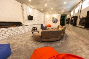 a living room with two couches in a room at Light Hostel by TripLE in Yakkasaray