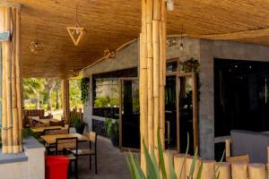 a patio with tables and chairs in a restaurant at La Roca in Kiryi +11 photos