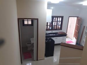 a bathroom with a sink and a toilet in a room at Ecovila in São Sebastião