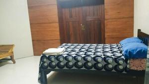 a bed in a room with a wooden door at RnR Suites in Dagupan