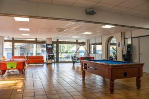 a room with a pool table in a building at Camping les Criques de Royan in Saint-Georges-de-Didonne