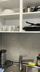a kitchen counter with dishes and pots and pans at Piso Chauderon in Lausanne