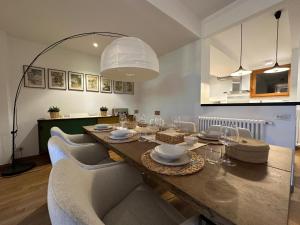 a dining room with a wooden table and chairs at LA CALETTA SUITE APARTMENT- Panoramic Shared Pool, Secured Parking, Water Activities in Blevio