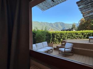 a balcony with two chairs and a table and a patio at LA CALETTA SUITE APARTMENT- Panoramic Shared Pool, Secured Parking, Water Activities in Blevio