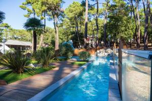 a pool at a theme park with a slide at Camping les Criques de Royan in Saint-Georges-de-Didonne