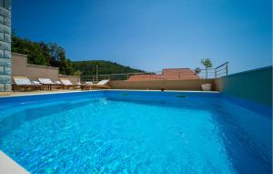 a large blue swimming pool on top of a house at Holiday Home Brna V in Brna +50 photos