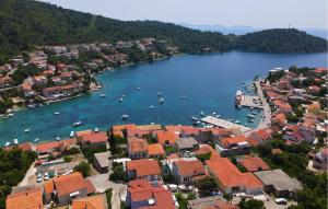 an aerial view of a town with boats in the water at Holiday Home Brna V in Brna