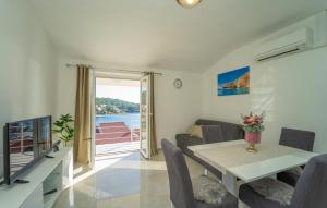 a living room with a table and a couch at Holiday Home Brna V in Brna