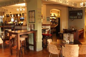 a restaurant with tables and chairs and a bar at The Menai Hotel and Bar in Bangor