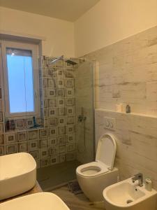 a bathroom with a toilet and a sink and a shower at Pella House in Airasca +11 photos