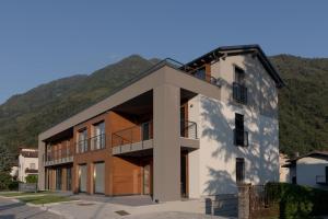 a building with a mountain in the background at CT Executive Rooms, Lake Como and Valtellina in Dubino