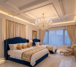 two beds in a hotel room with a chandelier at Awex Apart in Sakarya