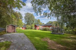 a grassy yard with houses and a goal at Rustic Nordic Getaway by the Sea in Axmar