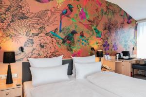a bedroom with a bed with a colorful wall at Parkhotel Bad Homburg in Bad Homburg vor der Höhe +116 photos
