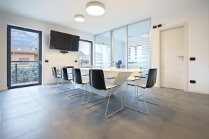 a dining room with a white table and chairs at CT Executive Rooms, Lake Como and Valtellina in Dubino