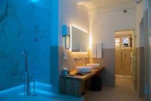 a bathroom with two sinks on a wooden counter at Rose Iconic Rooms in Lecce +60 photos