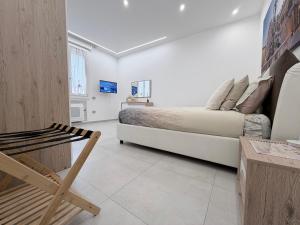 a bedroom with a bed and a chair in it at Dream Suite Bologna in Bologna