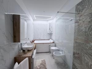 a white bathroom with a sink and a toilet at Dream Suite Bologna in Bologna +118 photos