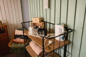 a room with a table with a shelf with coffee makers at Luxury Suite in Heerewaarden