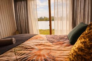 a bedroom with a bed with a view of a window at Luxury Suite in Heerewaarden +4 photos