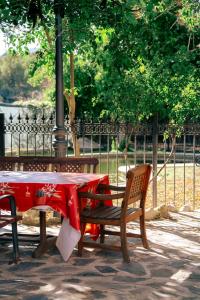 a table and two chairs with a red table and bench at Finca Vitoria in Moratalla