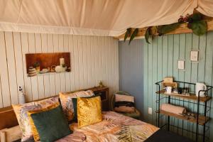a bedroom with a bed with a canopy above it at Luxury Suite in Heerewaarden