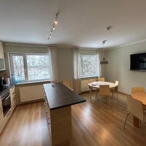 a kitchen and dining room with a table and a dining room at Wallamaja Hostel in Järvakandi