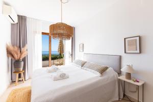 a bedroom with a white bed with towels on it at Finca Sol y Cielo in Cajís +58 photos