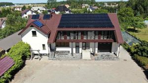 an aerial view of a house with solar panels on its roof at Antano sodyba in Dauparai