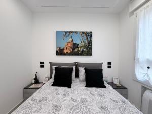 a bedroom with a bed and a picture on the wall at Dream Suite Bologna in Bologna