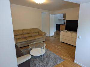 a living room with a couch and a table at A charming countryside accommodation near Malm in Oxie