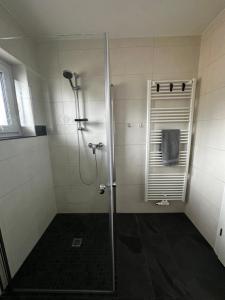 a shower with a glass door in a bathroom at Mia's Landzeit in Nettersheim +16 photos