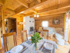 a dining room and living room with a table in a cabin at Domek z bali in Jarnołtówek +17 photos